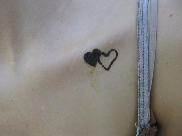 tattoos for guys chest. heart tattoos for men.