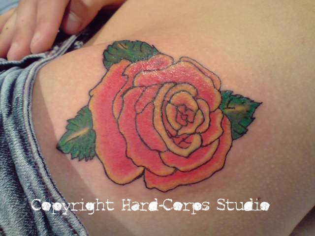 Rose tattoo on the hip by